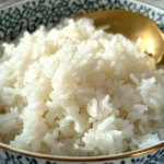 Fluffy rice in a bowl with a golden spoon