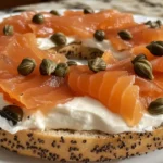 Fresh bagel with cream cheese and smoked salmon on a plate