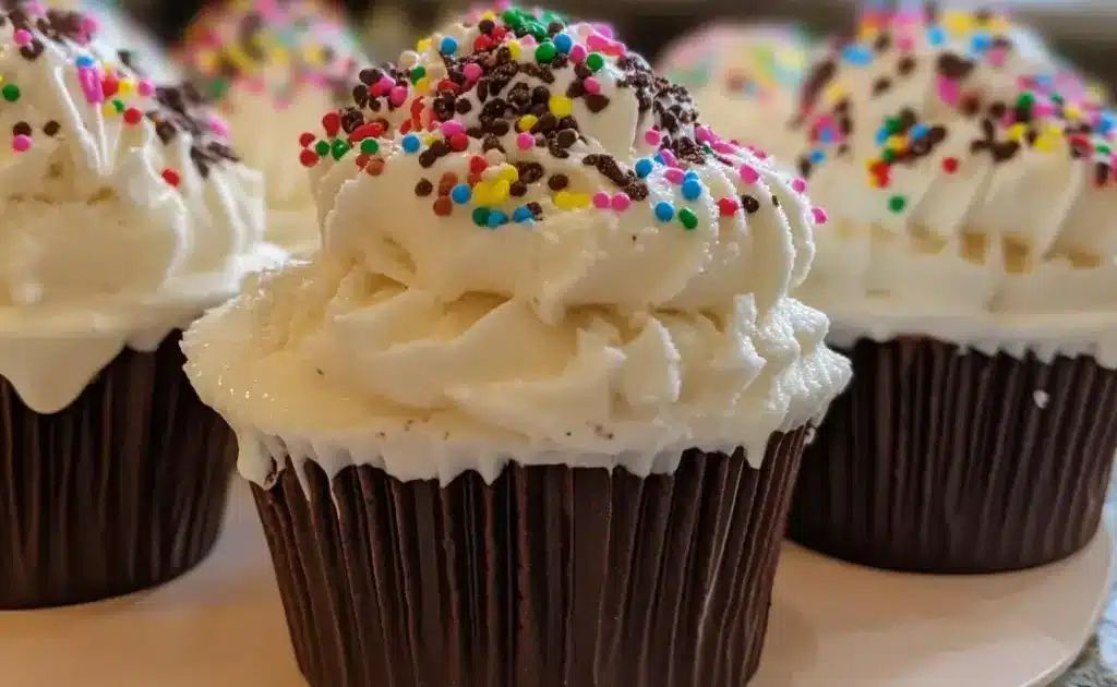 Homemade ice cream cups in paper liners on a wooden board